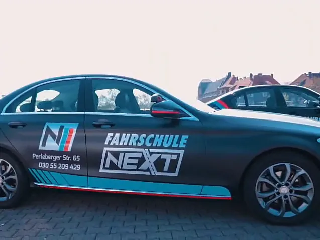 Mercedes C-Class from the side with Fahrschule Next lettering